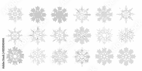 Collection of delicate gray snowflakes in various intricate designs and arrangements