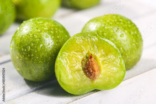 Photos Fresh Green Plums with Pit - Healthy Crisp Fruit