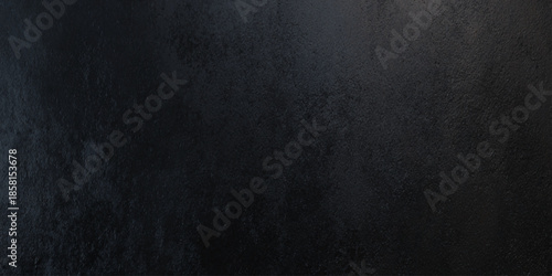A dark textured background with subtle variations in shade and tone creating a moody and atmospheric visual effect