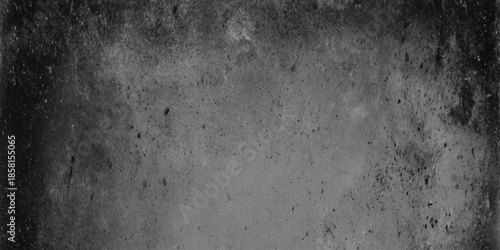 A grayscale textured image depicting a distressed dark surface with subtle variations in tone and speckling