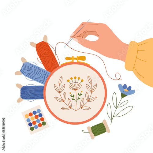 A hand gently sewing intricate floral designs in an embroidery hoop, surrounded by vibrant threads in red, blue, and green, capturing creativity and artistic expression.