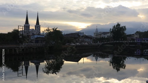 This waterfront video view in a riverside community in Chanthaburi shows the lights and houses along the water, as well as a Christian church – a beautiful tourist attraction in Thailand.