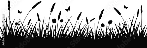 Silhouette of Meadow Grass and Butterflies at Sunset