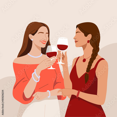 Two elegantly dressed women share a moment of joy while toasting with red wine in a sophisticated setting, capturing friendship and celebration beautifully.