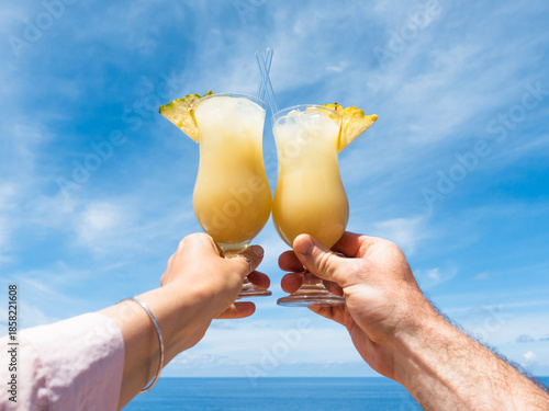 Men's and women's hands and glasses with drinks. Cruise ship deck. Against the backdrop of sea waves. Vacation and travel concept. Chill lifestyle, luxury travel. Perfect for holiday and travel themes
