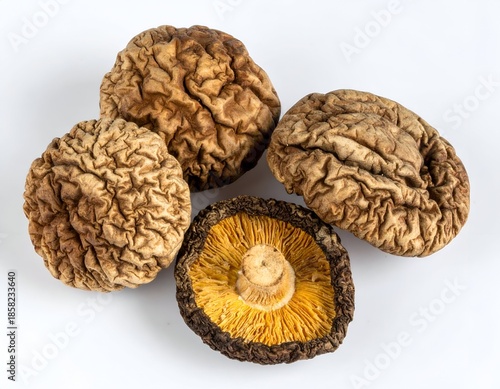 Dried mushrooms with textured caps and one showing the underside