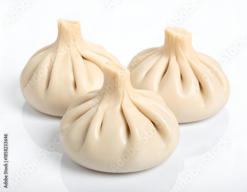 Three dumpling-like food items, white background, soft lighting