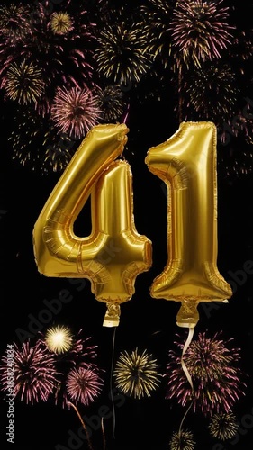 Gold balloon number 41 with fireworks in the background. Festive scene for birthday or anniversary party