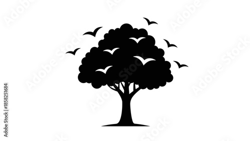 Silhouette of a Tree with Birds Flying Around.