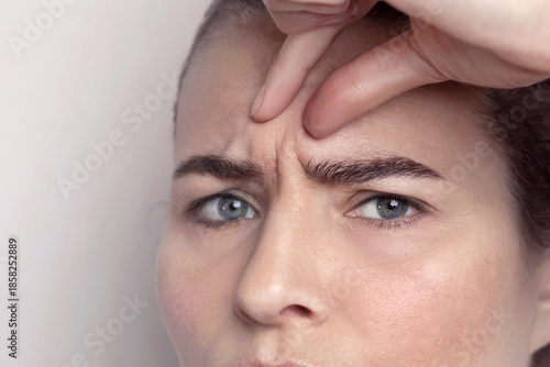 Canvas Print Glabellar lines, folds in a middle-aged woman with blue eyes