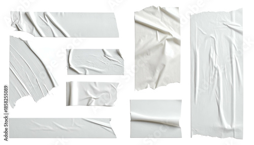 Isolated pieces of white, crinkled adhesive tape on a black background, with torn edges