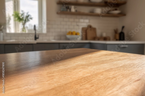 Wooden tabletop with blurred warm kitchen background and sunlight.	