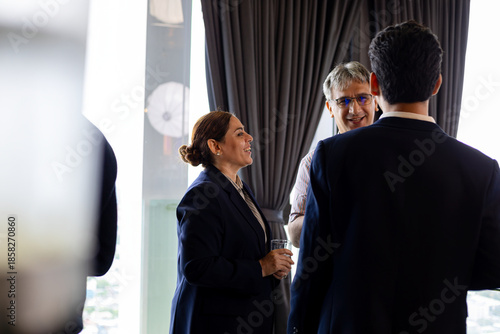 Wallpaper Mural Group of business professionals networking and smiling during corporate event, showcasing positive workplace communication and relationship building in modern business environment Torontodigital.ca
