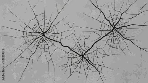 Spiderweb-like cracks on a gray surface, perfect for adding a touch of spooky or grunge