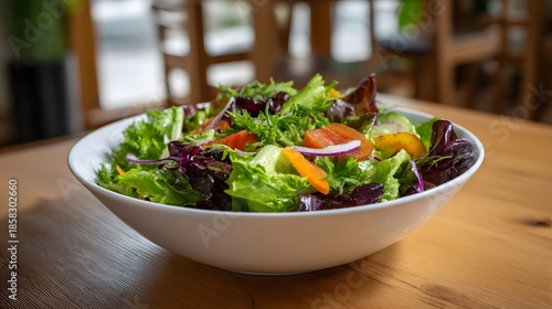 Wallpaper Mural A vibrant bowl of fresh mixed greens salad with colorful vegetables served on a wooden table Torontodigital.ca