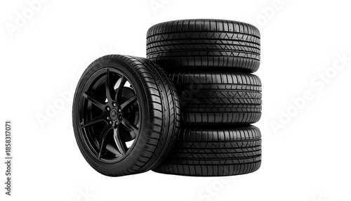 Stack of black car tires with a focus on tread pattern and rim details on a dark background