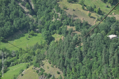 Stunning mountain landscape with trees and farmland captured from a cable car in summer