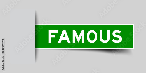Green color square shape sticker label with word famous inserted in gray background
