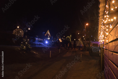 Magical Christmas village illuminated at night with festive lights