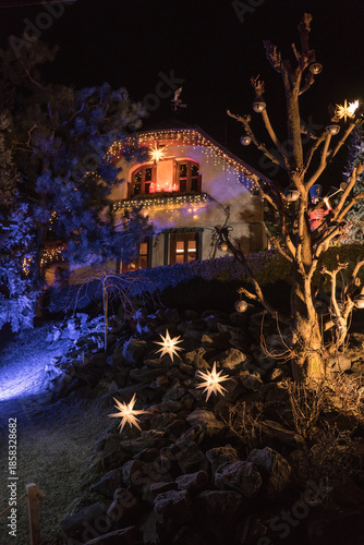 Magical Christmas village illuminated at night with festive lights