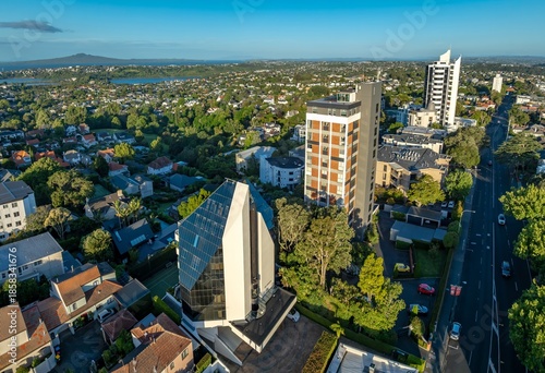 Aerial view of Remuera, Auckland, New Zealand, showcasing residential buildings and the city skyline. The photo highlights urban planning and architectural diversity.