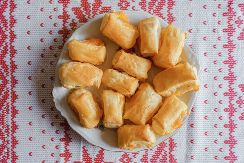 Assortment of freshly baked homemade cheese puff pastries on wood
