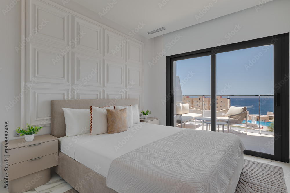 Fototapeta premium Modern Bedroom Interior with Sea View, Balcony, and Decorative Wall Paneling