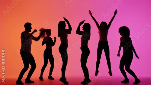 Energetic Silhouettes of Diverse People Dancing Joyfully Together Against a Vibrant Gradient