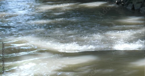 slightly murky river water flows