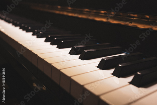 Upright piano details in cozy indoor night lighting