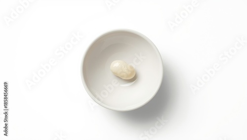 White kidney beans presented in a plain white ceramic bowl, highlighting plant-based protein sources