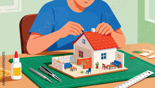 Person assembling a miniature house with tools, glue, and cutting mat