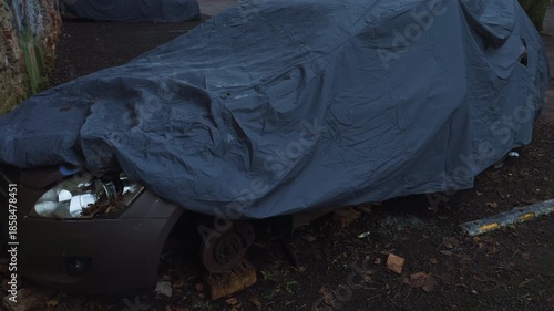 Wallpaper Mural Vehicle with missing wheel by graffiti wall, Neglected hatchback resting beside graffiticovered wall Torontodigital.ca