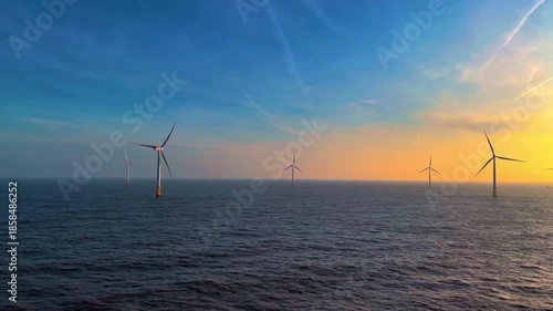 Wallpaper Mural Offshore windmills glow at dusk, Seafacing turbines illuminated at sunset with vibrant sky backdrop Torontodigital.ca