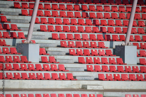 Empty Red Stadium Seats Background with Repeating Pattern and Copy Space