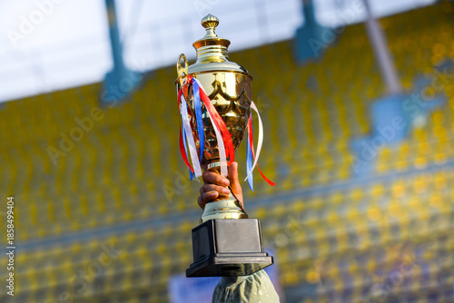 Victory Trophy in Hand at Stadium