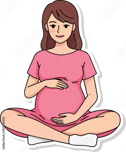 Pregnant woman in pink dress sits cross-legged holding her belly gently with a smile