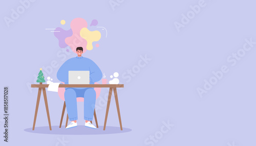 Man working remotely on laptop with a Christmas tree decoration showing creative ideas