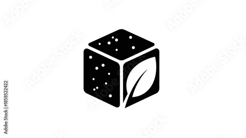 Black cube with a prominent white leaf on one face and speckled texture on another, representing natural or organic ingredients.
