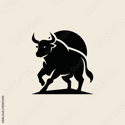 Bold silhouette of a bull with horns in dynamic stance on light background