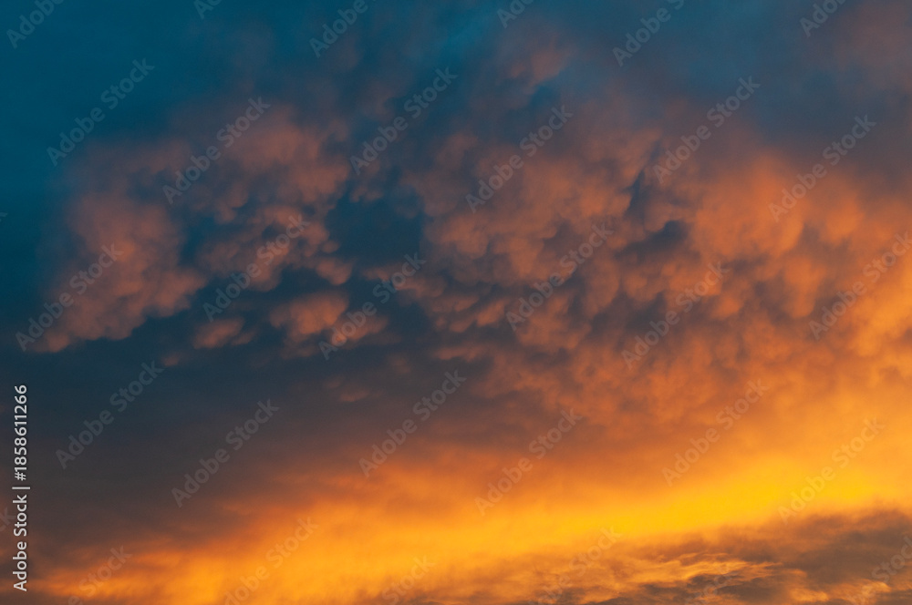Fototapeta premium Abstract colorful background. Beautiful red sunset over a small town. Dramatic sunset sky with clouds.
