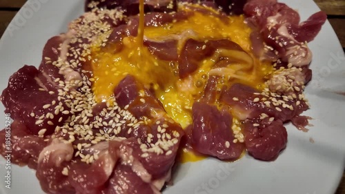 Gourmet Fresh Raw Meat Dish with Egg Yolk and Sesame Seeds Culinary Exploration of Vibrant Colors, Textures, and Protein Packed Cuisine for Food Lovers