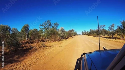 Sunset offroad driving with a 4WD on an Australian outback gravel road
