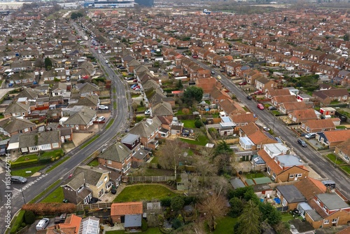 Aerial drone photo of the village of Huntington in the City of York in North Yorkshire England showing rows of typical British houses and housing estates with roads, streets and gardens from above