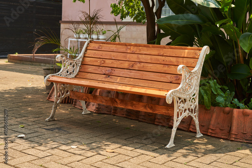 A classic wooden backrest bench in the outdoor area                          