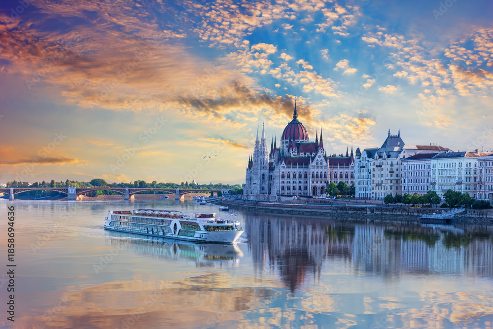 Obraz premium Aerial view of cruise ship and Budapest Parliament under sunrise sky, Hungary