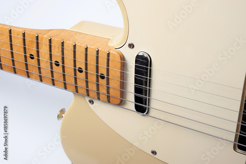Six-string electric guitar, with a cream-colored wooden body and chrome-plated fittings.