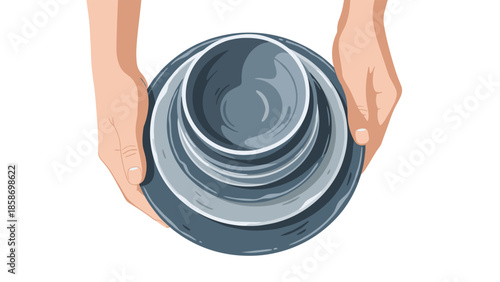 Hands carefully hold a neat stack of clean, grey ceramic plates and bowls, representing domestic chores and kitchen organization.