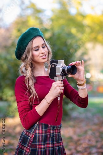 Pretty woman with vintage video camera