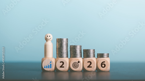 Stacks of coins with Calendar and wooden blocks forming number 2026 for target financial growth, investment planning for money savings, business goals concept. Budget and tax, Happy new year 2026